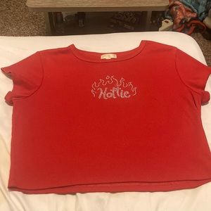 Cropped red shirt with design in rhinestones.